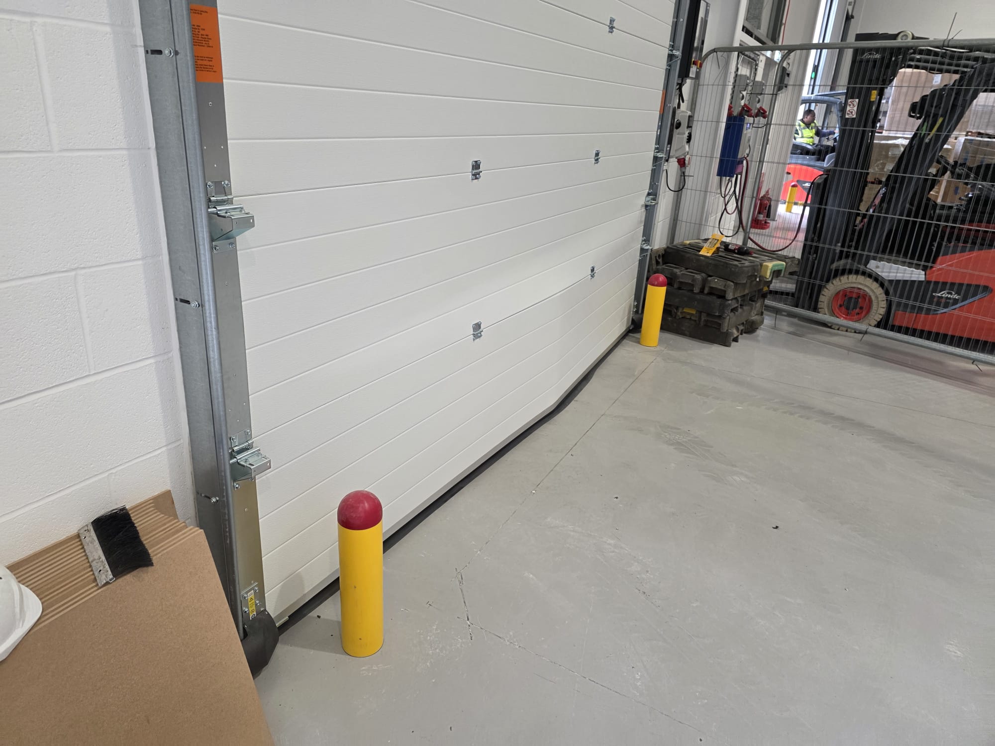 Impact damage to an industrial sectional door panel