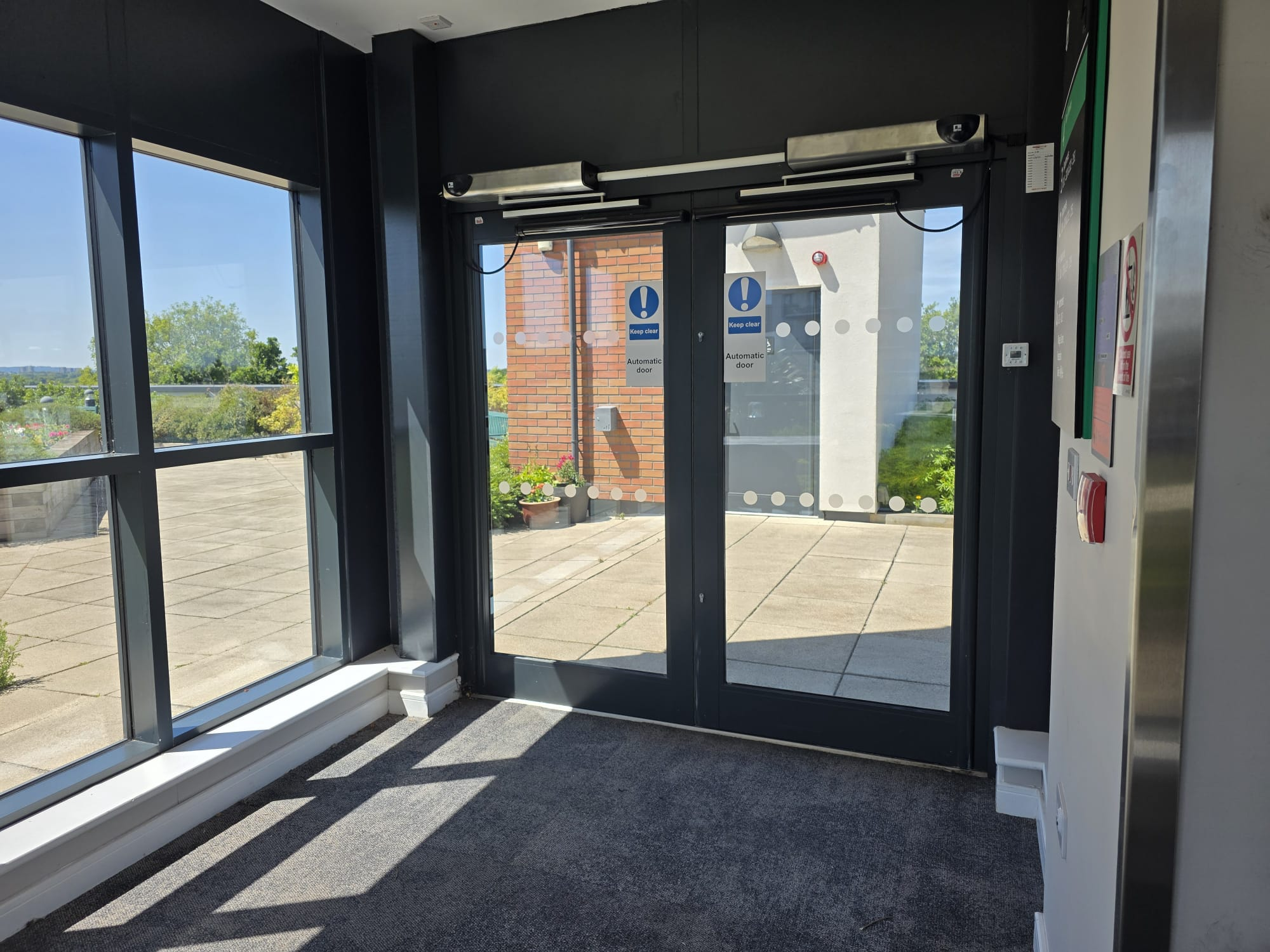 Automatic swing door operators fitted to glazed entrance doors