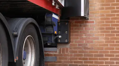 Fixed rubber dock buffer installed beside a vehicle