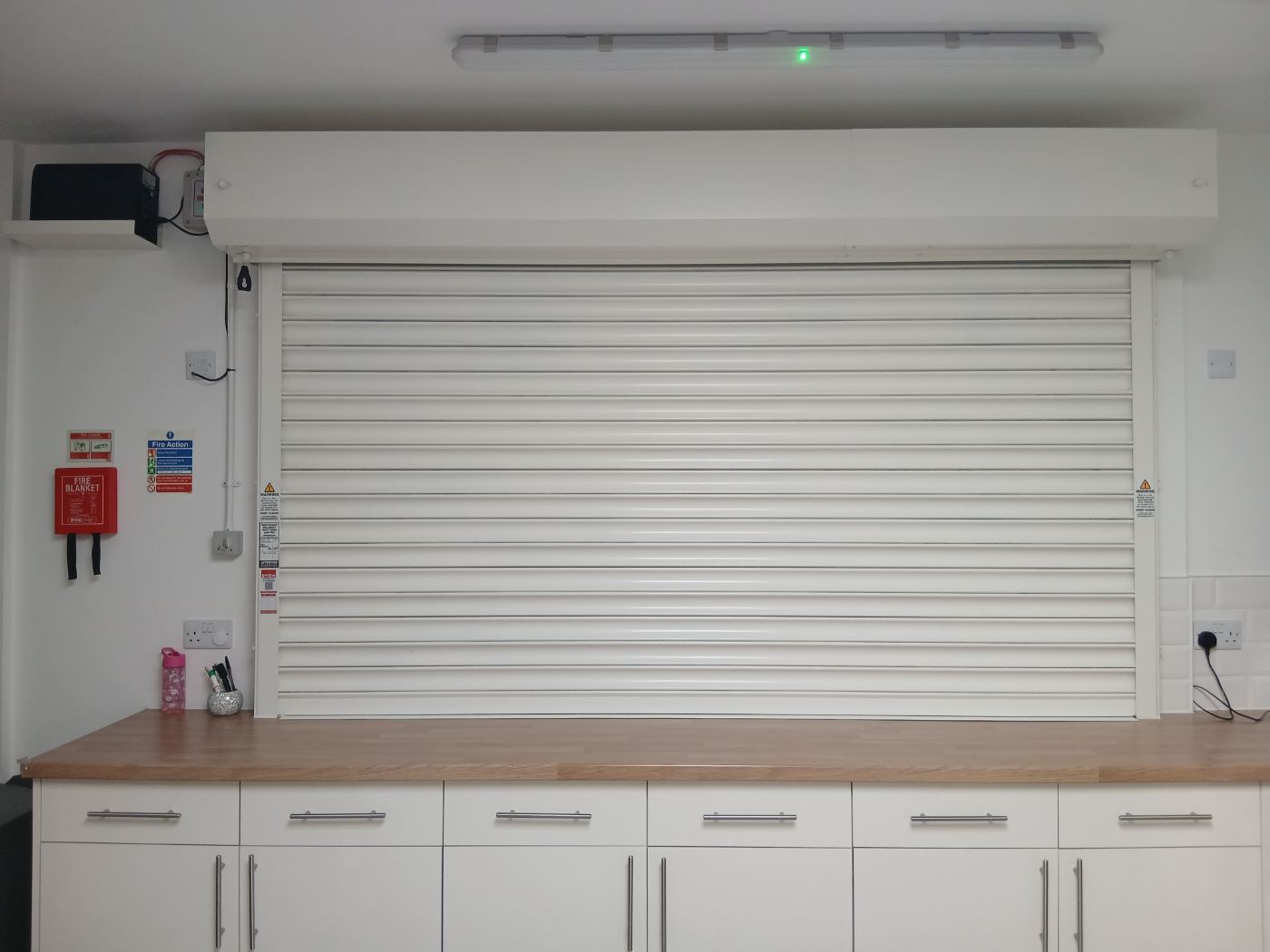 Fire roller shutter protecting a commercial kitchen servery