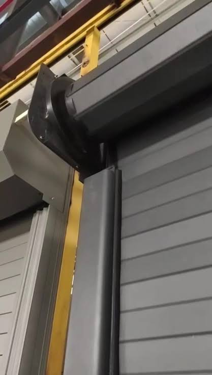 Close view of a high speed rigid roller shutter door guide and curtain