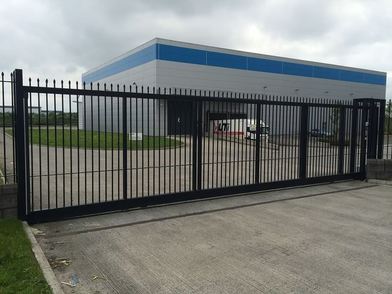 Large automatic sliding security gate at an industrial building