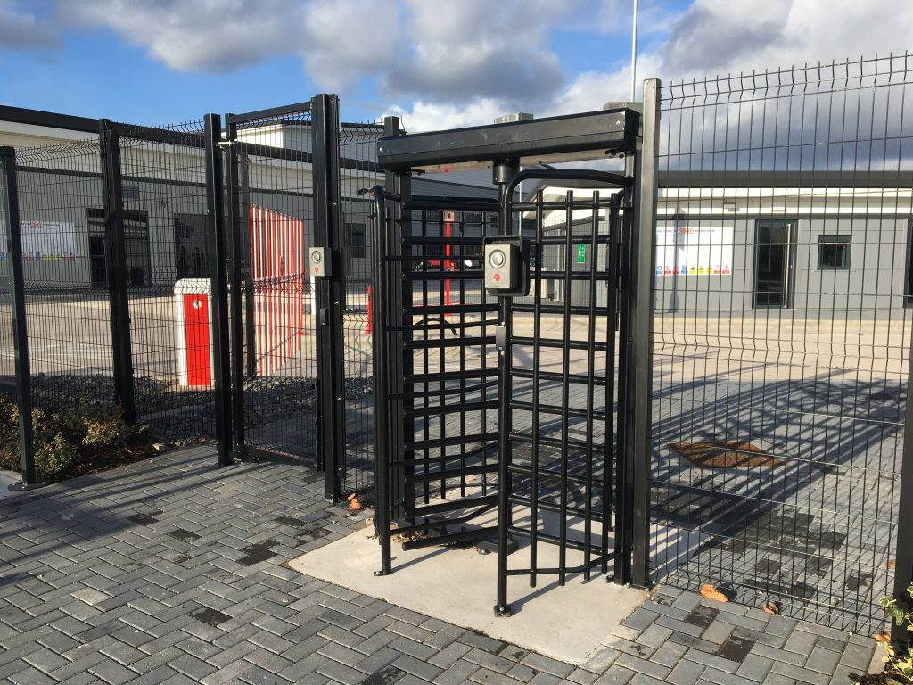 Full-height security turnstile at an industrial site