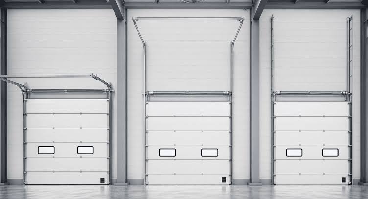 Sectional doors using different overhead track arrangements