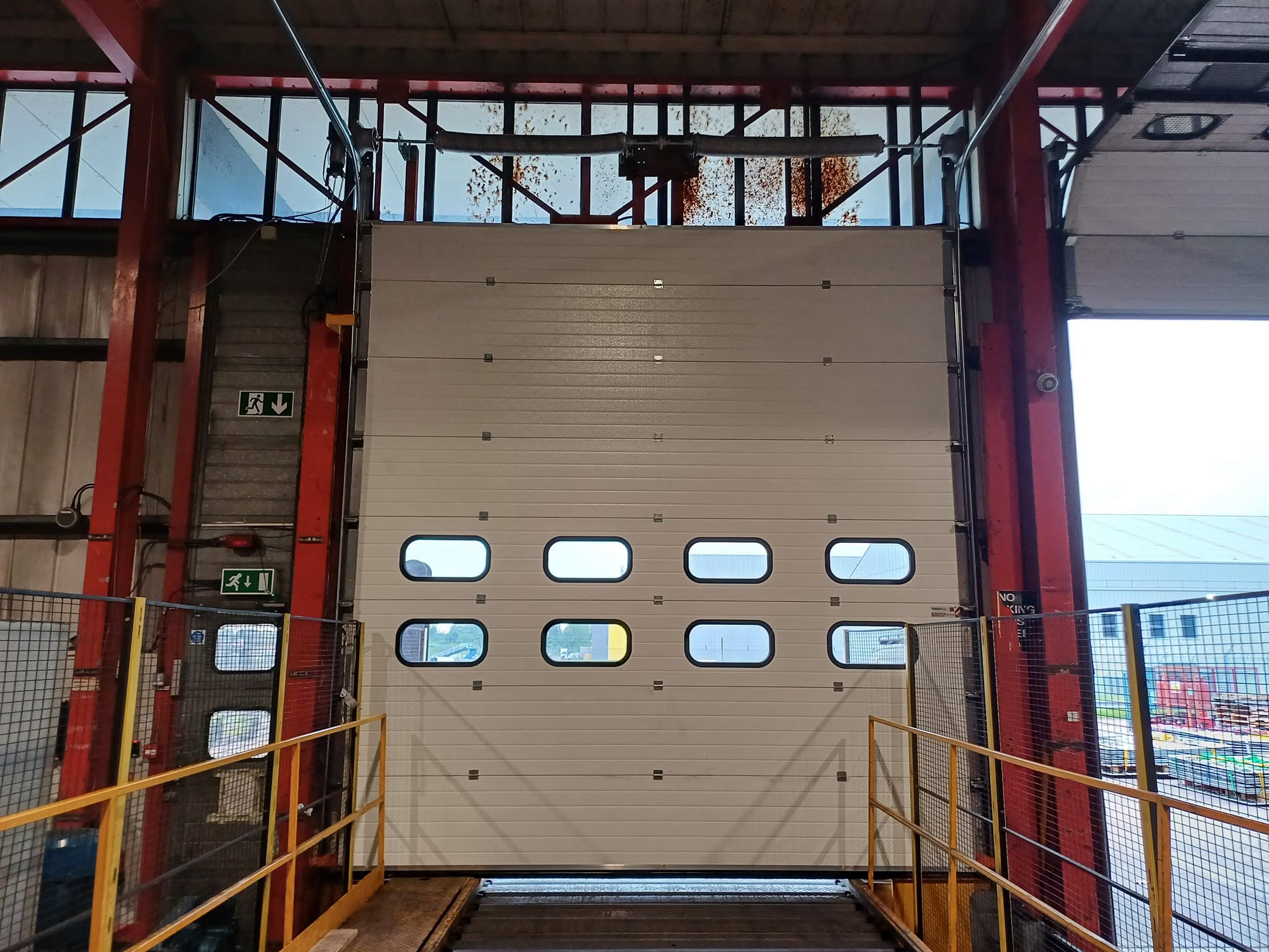 Industrial sectional door after EVICK replacement and modification work