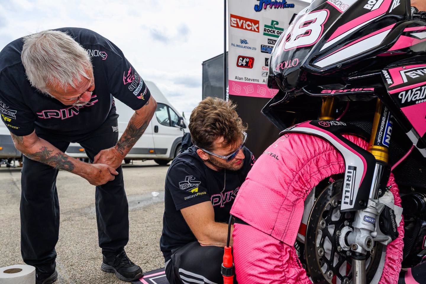 Go Pink Racing mechanics working on the Aprilia RS660